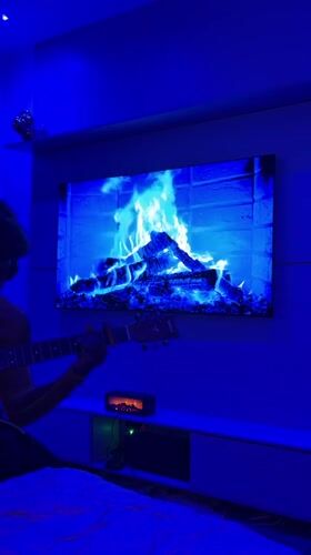 Guitarist performs in blue-lit room for social media challenge