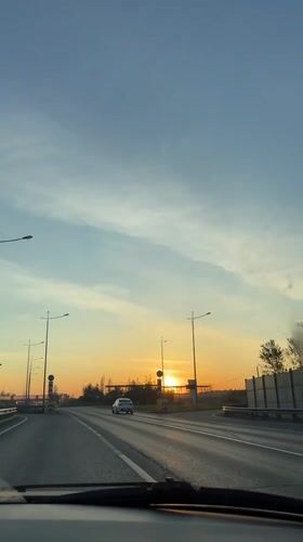 Driver records highway journey near Bolshoye Savino during golden hour
