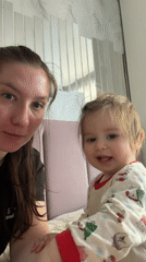 Woman and child share quiet moment on bed in Myaglovo