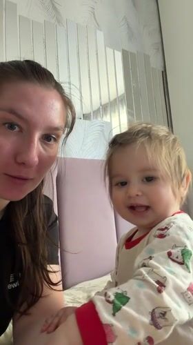 Woman and child share quiet moment on bed in Myaglovo