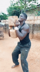 Man exercises with homemade wooden dumbbell outdoors