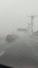 Heavy rainstorm reduces driving visibility in Kuta Selatan