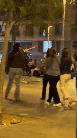 Young adults gather on Barcelona streets during Friday night