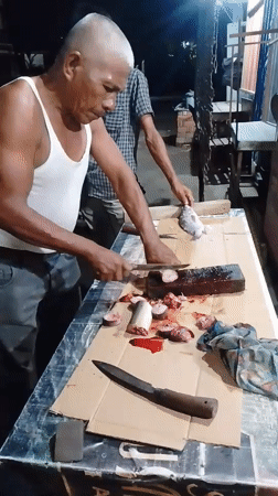 Fresh fish being prepped at a street-side workstation in Lhokseumawe