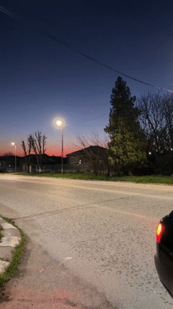 Evening traffic captured on illuminated street in Bulgarian village