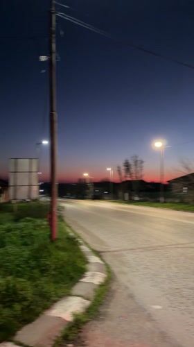 Evening traffic captured on illuminated street in Bulgarian village