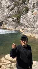 Person gestures at waterfall in Medven, Bulgaria