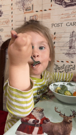 Toddler enjoys messy green meal in Chaikovsky, Russia