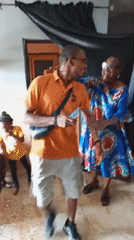 Multi-generational family celebrates birthday with dancing and decorations