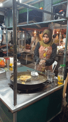 Evening street market bustles with vendors and shoppers in Ko Pha-ngan