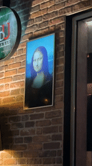 Interactive Mona Lisa artwork spotted on brick wall