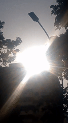 Evening sun creates starburst effect over Caracas buildings
