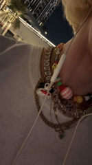 Person displays colorful beaded bracelet collection in Dubai