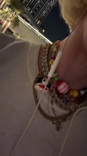 Person displays colorful beaded bracelet collection in Dubai