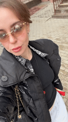 Woman films selfie video outdoors in Moscow