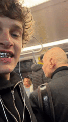 Young man records selfie video on Milan transit system