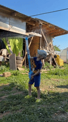 Boy plays with water gun in Russian backyard