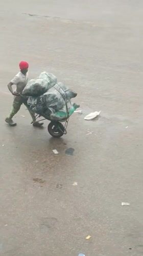 Morning street activity documented in rainy Bukuru, Nigeria