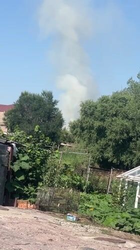 White smoke plume rises behind residential building, seen from multiple angles