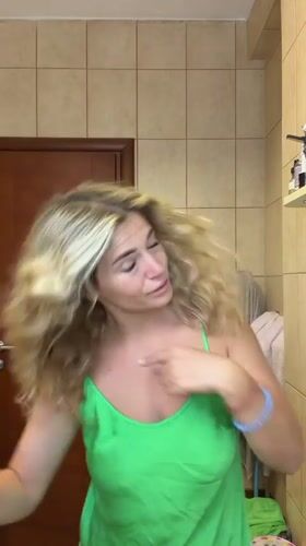 Hairspray moment in a Budva bathroom, August 2026