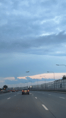 Plane spotted crossing twilight sky above Saint Petersburg highway
