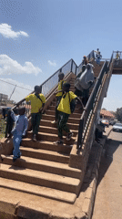 Schoolchildren cross pedestrian bridge in Gura Top, Nigeria
