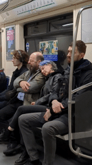 Blue-haired woman sleeps on stranger's shoulder during subway ride
