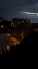 City evening unfolds from dusk to rainy night