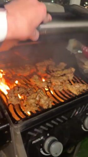 Evening barbecue cooking captured in Netanya urban setting