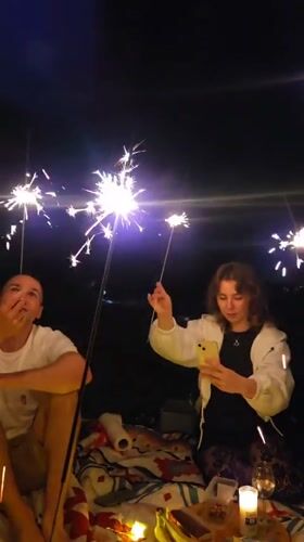 Late-night hillside picnic in Krakow with candles and sparklers
