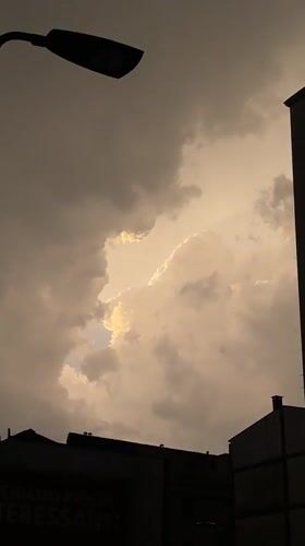 Overcast skies and rain observed in Milan evening