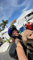 Couple rides motorcycle with poodle passenger in North Kuta