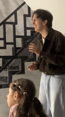 Man serenades girl in Russian home with dogs, flowers