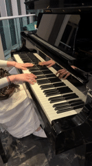 Woman plays grand piano in London evening performance