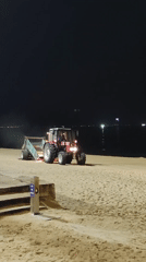 Nha Trang beachfront at night — promenade, market lights, beach cleaning
