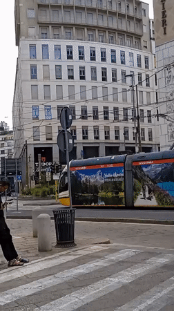 Morning tram traffic and street life in central Milan