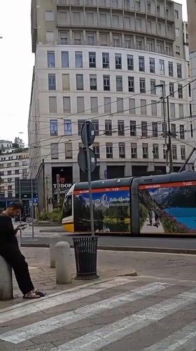 Morning tram traffic and street life in central Milan