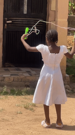 Girl jumps rope on sunny day in Gura Top