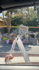 Seven hold encouraging signs during roadside gathering in Indio