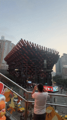 Tourists photograph Raffles City landmark in Chongqing's Yuzhong District