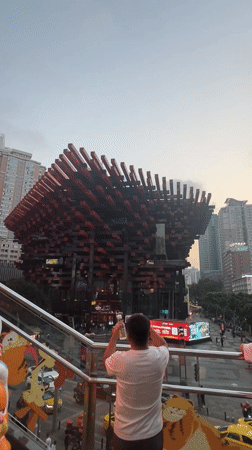 Tourists photograph Raffles City landmark in Chongqing's Yuzhong District