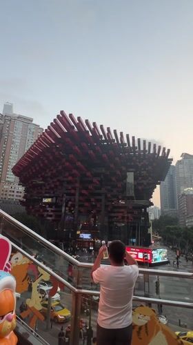 Tourists photograph Raffles City landmark in Chongqing's Yuzhong District