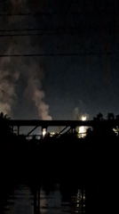 Nighttime fireworks display creates illuminated smoke plume over Palohlada waters