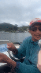 Motorboat passengers travel to lakeside temple complex in Baturiti