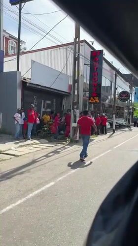 Red-clad crowd gathers on Delkanda street, Sri Lanka