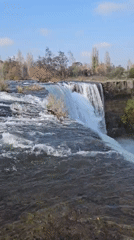 Tourists document scenic Laja Falls waterfall in Cabrero, Chile