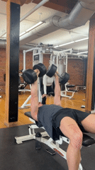 Man exercises with dumbbells at Montreal gym