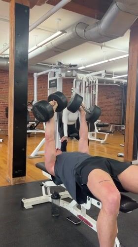 Man exercises with dumbbells at Montreal gym