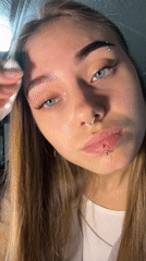 Woman removes makeup late night in Russian village