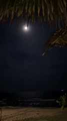 Full moon illuminates tranquil beach scene in Thailand